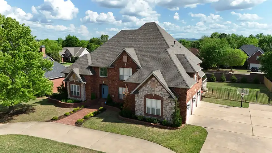 Red-brick two-storey home with a new weathered-wood shingle roof, seen from above