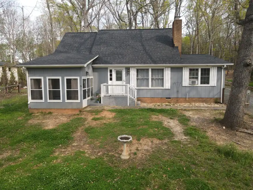 Steep dormered roof with new designer shingles, photographed by drone after a Richardson Roofing replacement